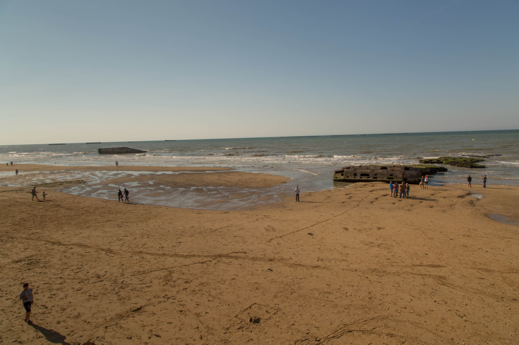 The beach at Arromanches with vestiges of the Mulberry Harbor visible. 